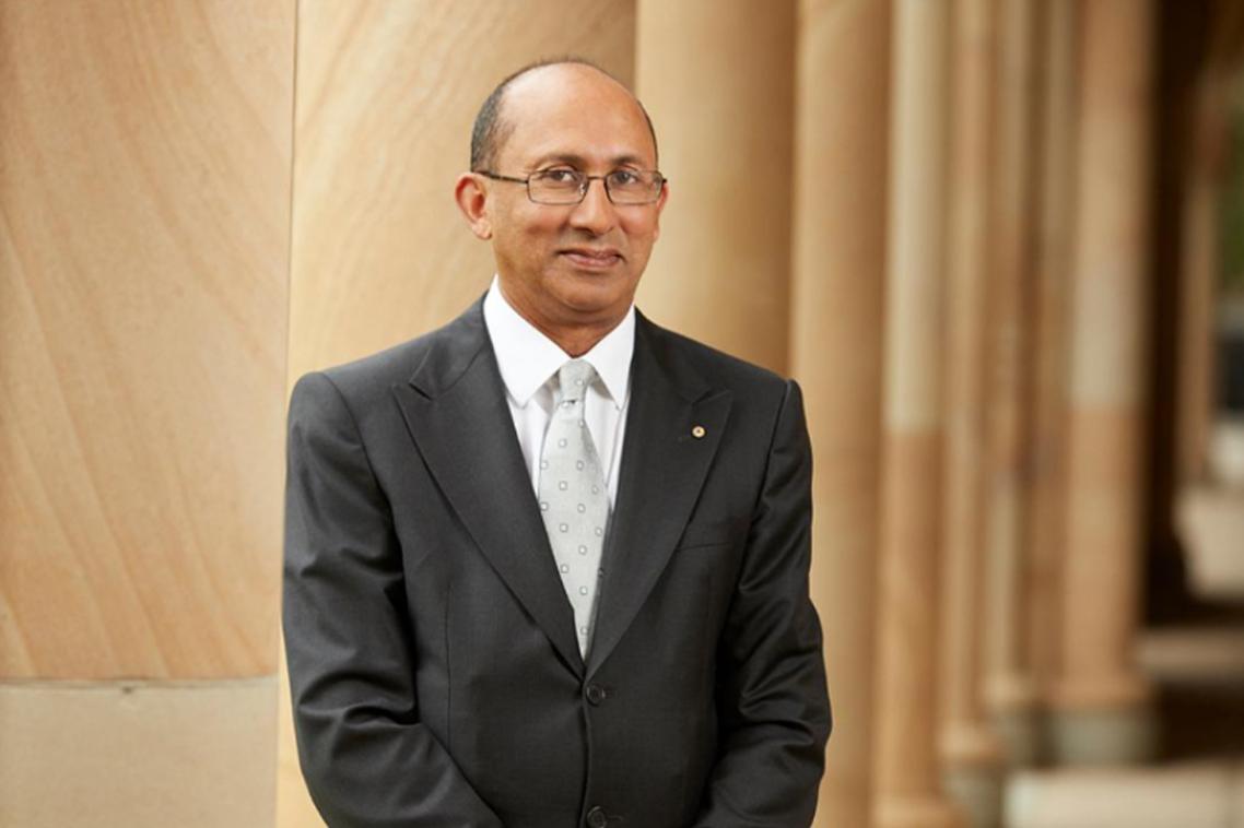 Peter Varghese standing in the UQ Great Court.