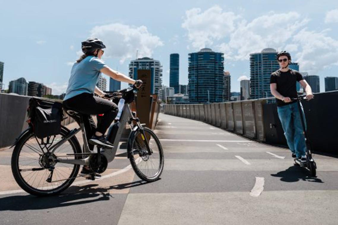 A woman riding an e-bike and a man riding an e-bike
